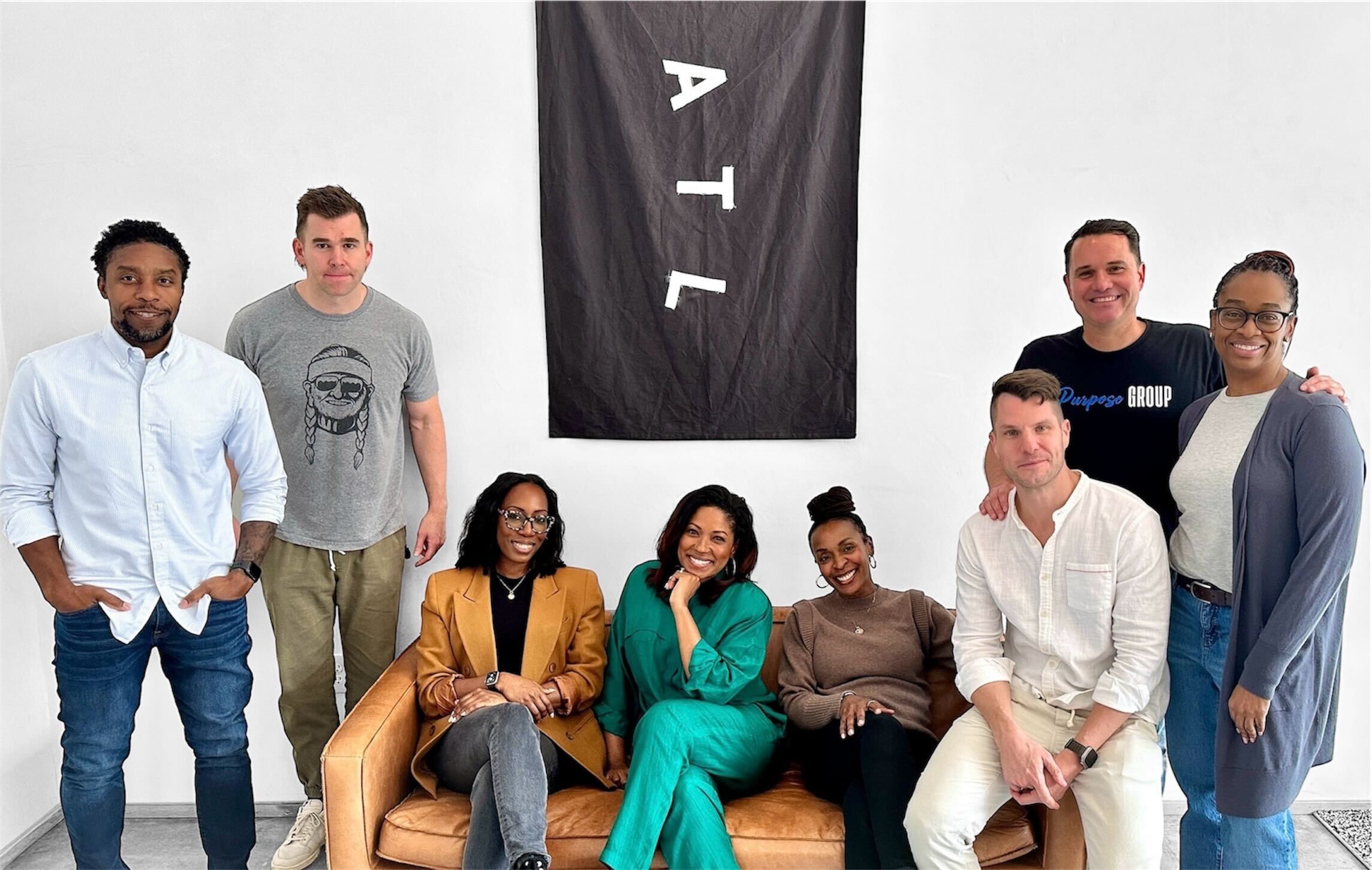 The Board Members of The A Pledge around a black flag with the initials for the city of Atlanta